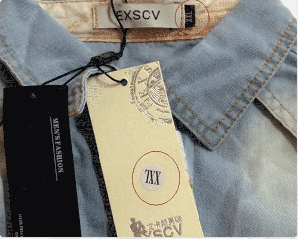 Close-up of a denim shirt collar with its neck label and a hang tag attached